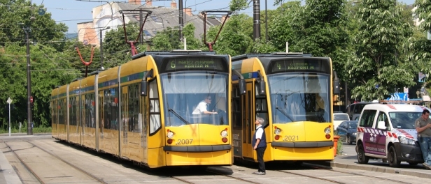 V prostoru přestupního uzlu Széll Kálmán tér vyčkávající vozy Siemens Combino Supra NF12B #2007 na lince 6 a #2021 na lince 4 na svůj čas odjezdu. | 28.6.2017